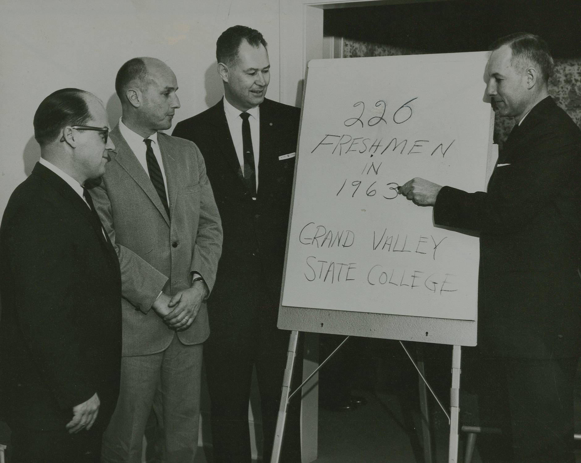Dr. Arnold C. Ott (left) plans the future Grand Valley State University